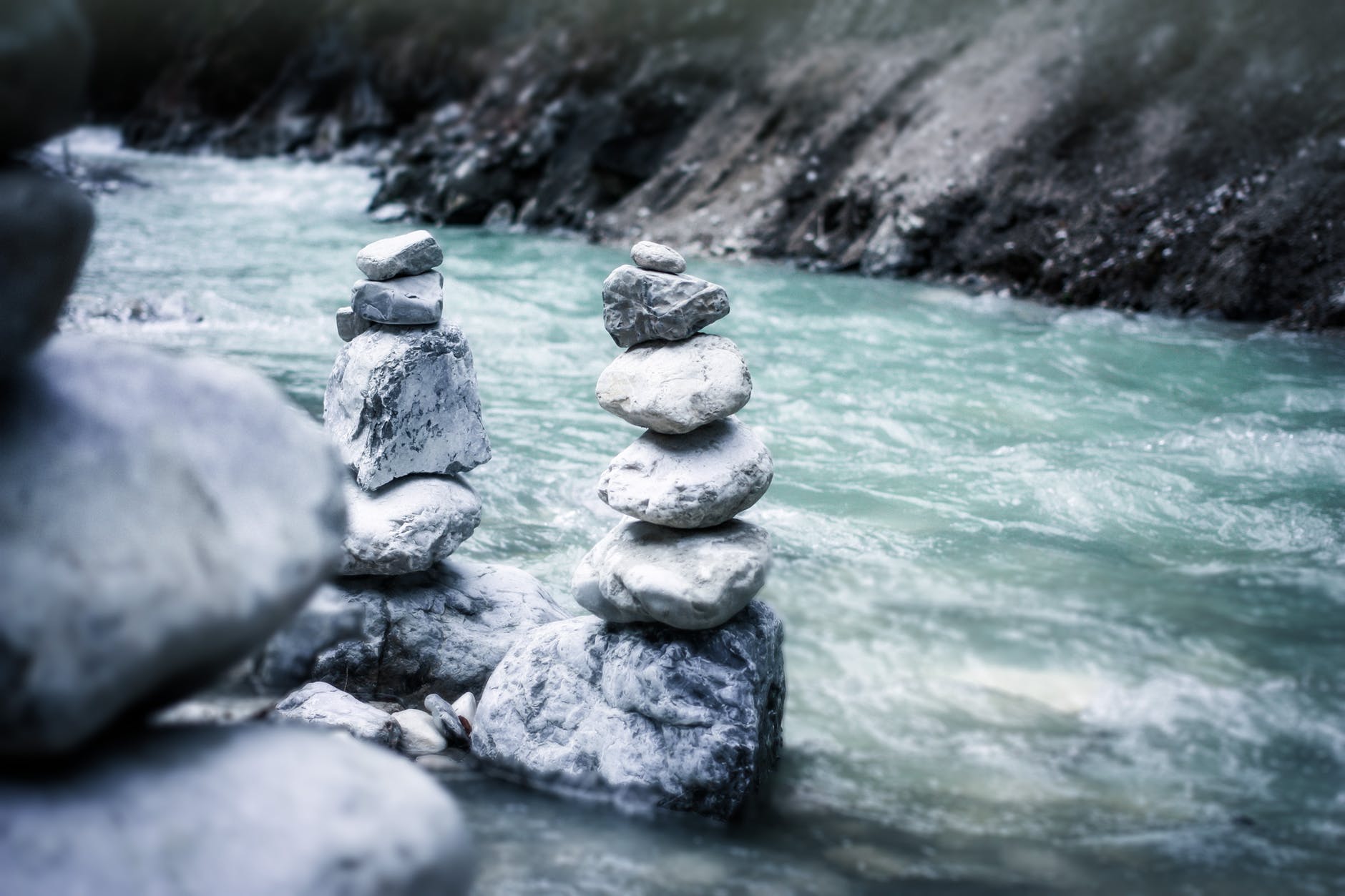 gray stock pile stone near river in gray scale photo